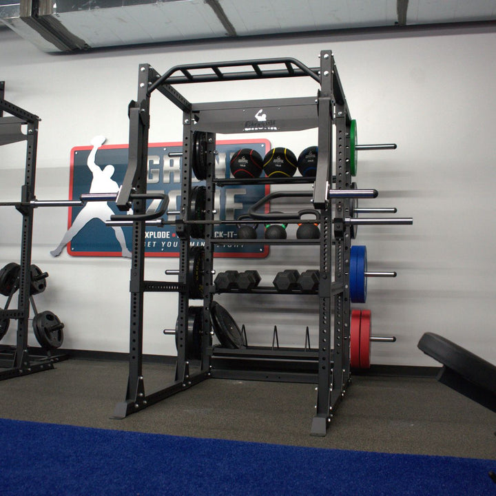 Gym equipment including a power rack and weight plates in a fitness center.
