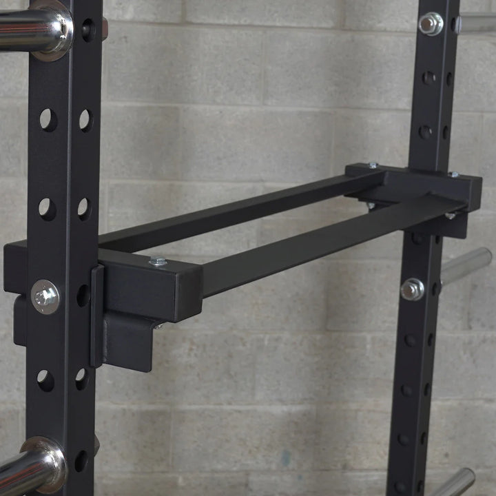 Black metal weight rack against a gray tiled wall