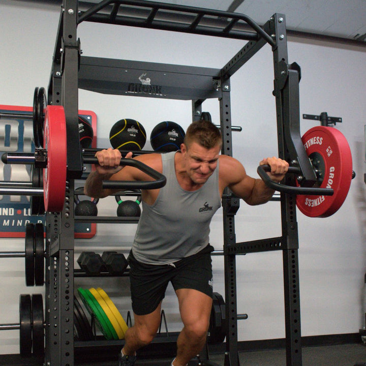 Man exercising with a barbell in a gym setting